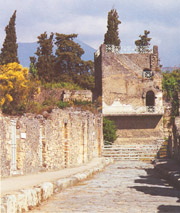 MERCURIO STREET WITH THE TOWER IN THE BACKGROUND IN POMPEII